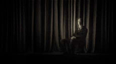 man in front of a curtain